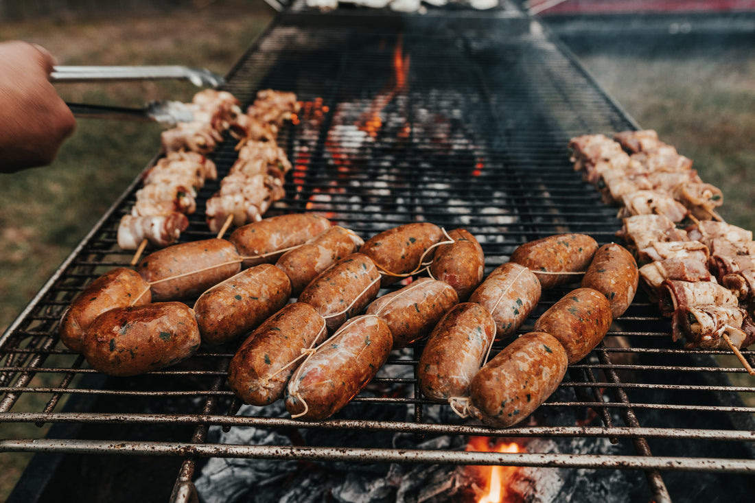 Grill tongs used to cook sausages on grill