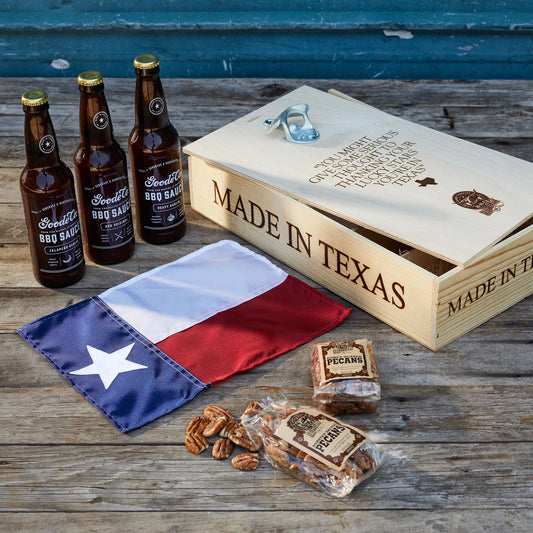 Made in Texas gift box with Texas flag, a few bags of pecans, and three bottles of BBQ sauce.