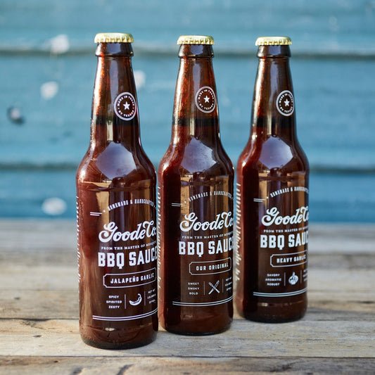 closeup photo of the Goode Co. trio of small BBQ sauce bottles.