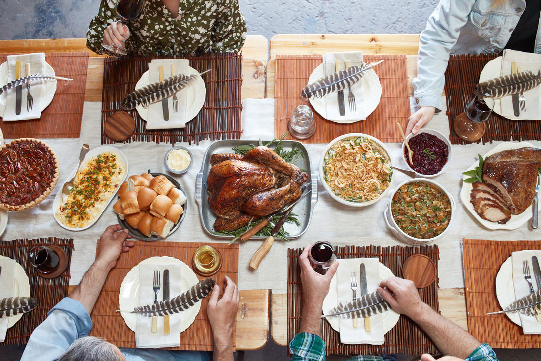 Tablescape with BBQ dishes and people eating