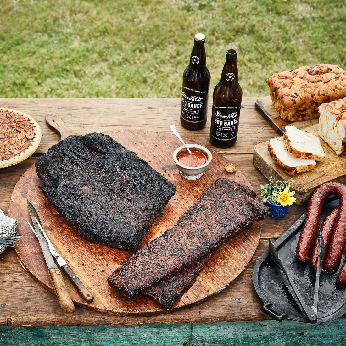 Honor Texas history with The Pride of Sam Houston BBQ pack from Goode Co. Featuring brisket, ribs, sausages, BBQ sauce, cheese bread, & a pecan pie.