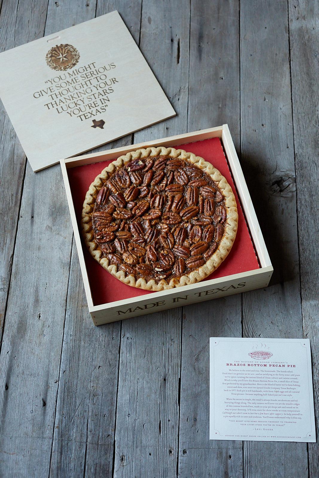 Overhead photo of pecan pie box with pie, certificate of authenticity, and lid to pie box.