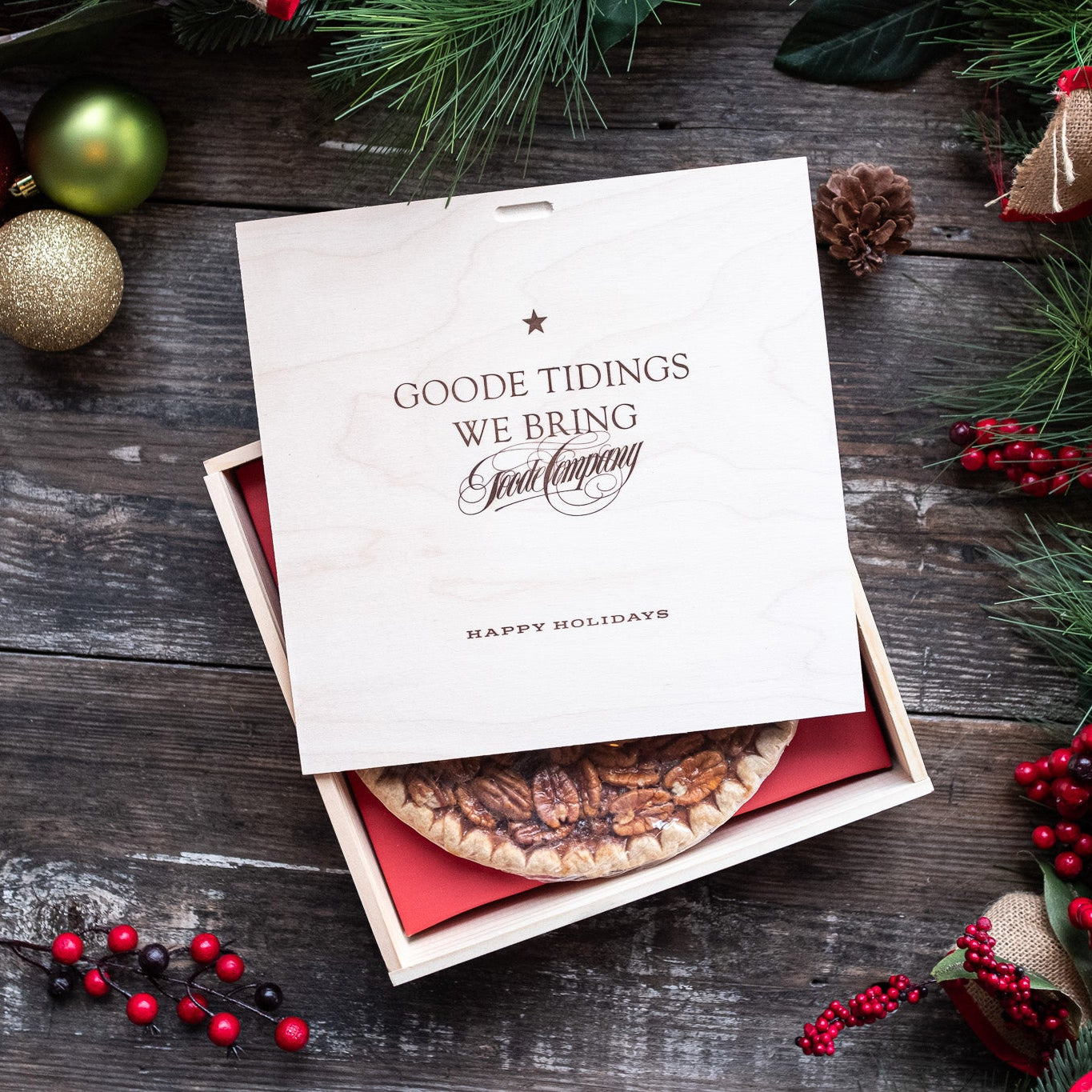 Pecan pie in wooden gift box engraved with the words "Goode Tidings We Bring"